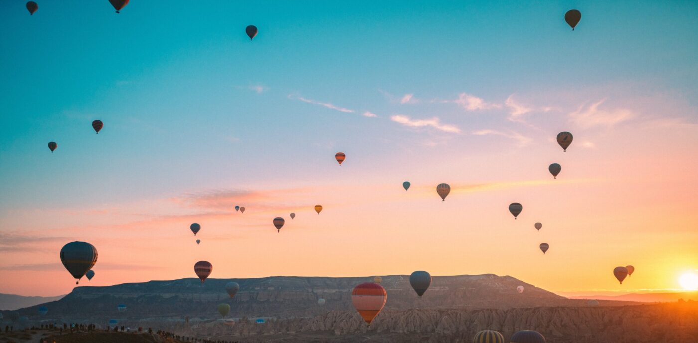 hot air balloons over mountains