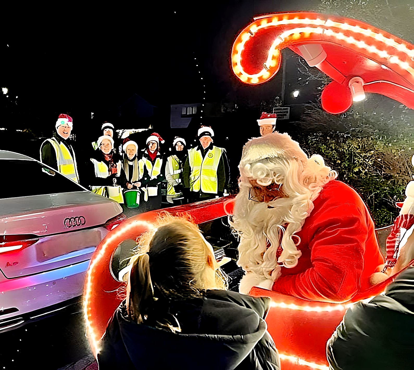 santa in his sleigh speaking with a girl